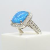 A silver square blue opalite and cubic zirconia halo ring