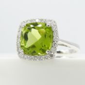 A dazzling 18ct white gold 2.75 carat cushion-cut peridot and diamond cluster ring