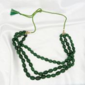 A large, weighty earth-mined carved emerald 3-strand bead necklace