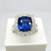 A fine quality 18ct white gold large cushion sapphire and diamond halo ring with diamond shoulders