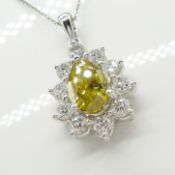 A superb yellow and white diamond pear-shaped pendant and chain in platinum, with certificate