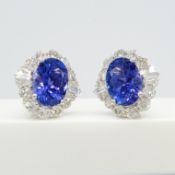 A large pair of loupe-clean tanzanite and diamond cluster earrings in 18ct white gold, certificated