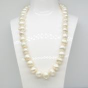 A necklace strung with natural freshwater pearls and fitted with a white gold ball clasp