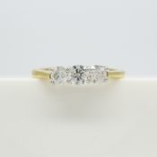 A 0.50 carat graduated round brilliant-cut diamond trilogy ring in 18ct yellow and white gold