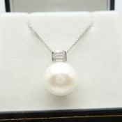 A large round cultured pearl and cubic zirconia-set silver necklace, with box