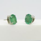 A pair of natural green emerald gemstone ear studs in silver