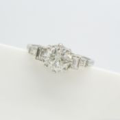 A platinum 1.30ct diamond ring with a round brilliant-cut diamonds and baguette diamond shoulders