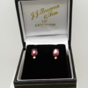 A pair of ruby and diamond ear studs in 18ct yellow gold, boxed