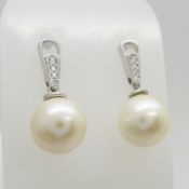 A pair of Art Deco-style cultured pearl & diamond tapered bale drop stud earrings in 9ct white gold.