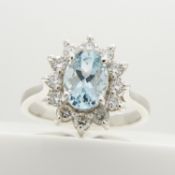 An aquamarine and diamond cluster dress ring in 18ct white gold
