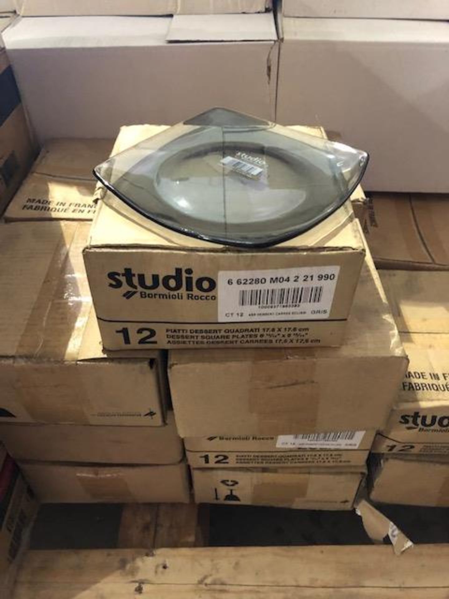 17 boxes of studio square plates