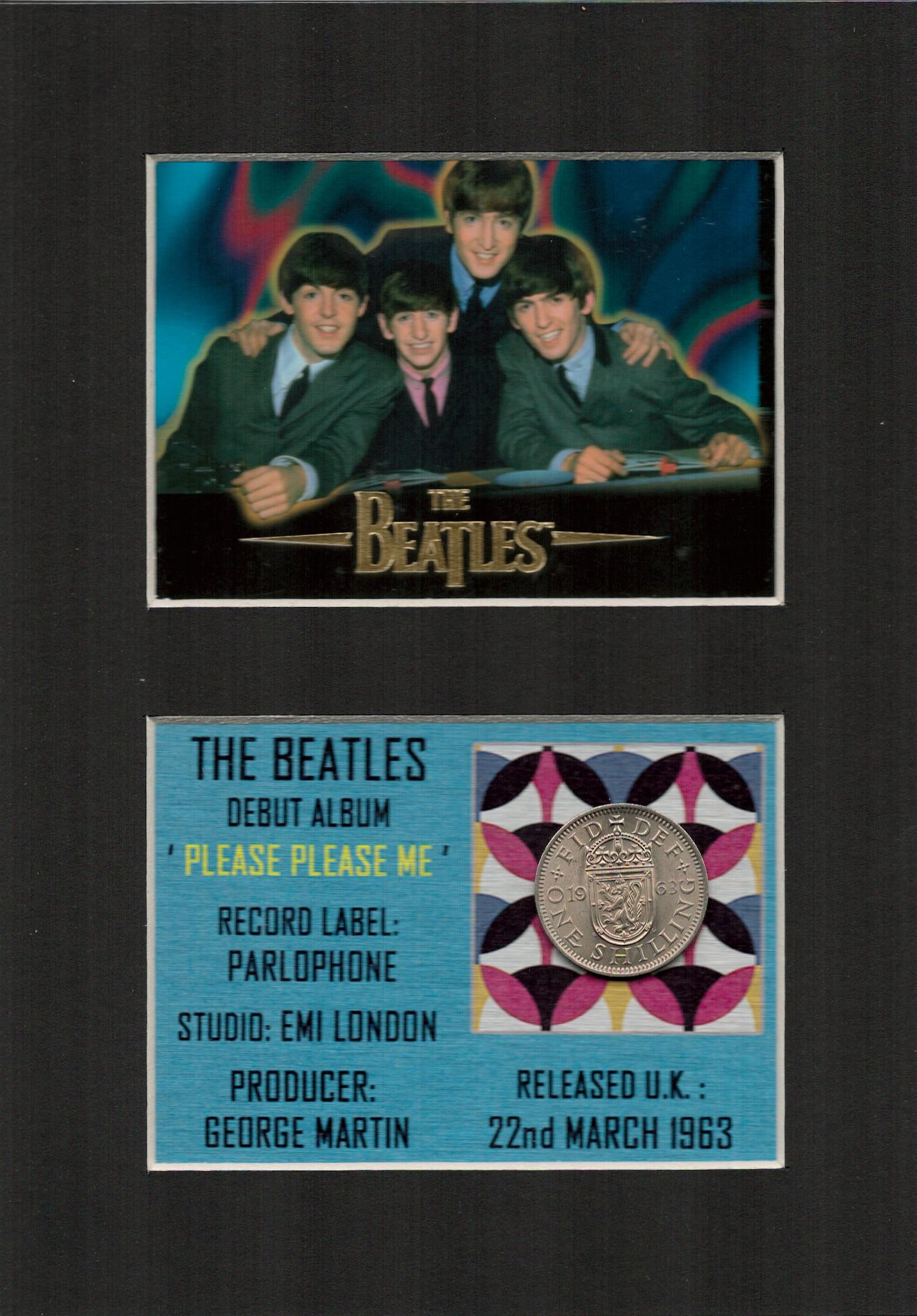 The Beatles First Album Release Mounted Coin Gift Set.