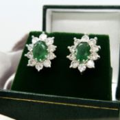 Pair of yellow and white gold emerald and diamond cluster earrings, boxed