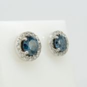 Pair of white gold blue and white diamond cluster ear studs, with box Blue diamonds: natural, tr...