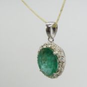Oval-cut emerald and diamond halo pendant in 18ct white gold