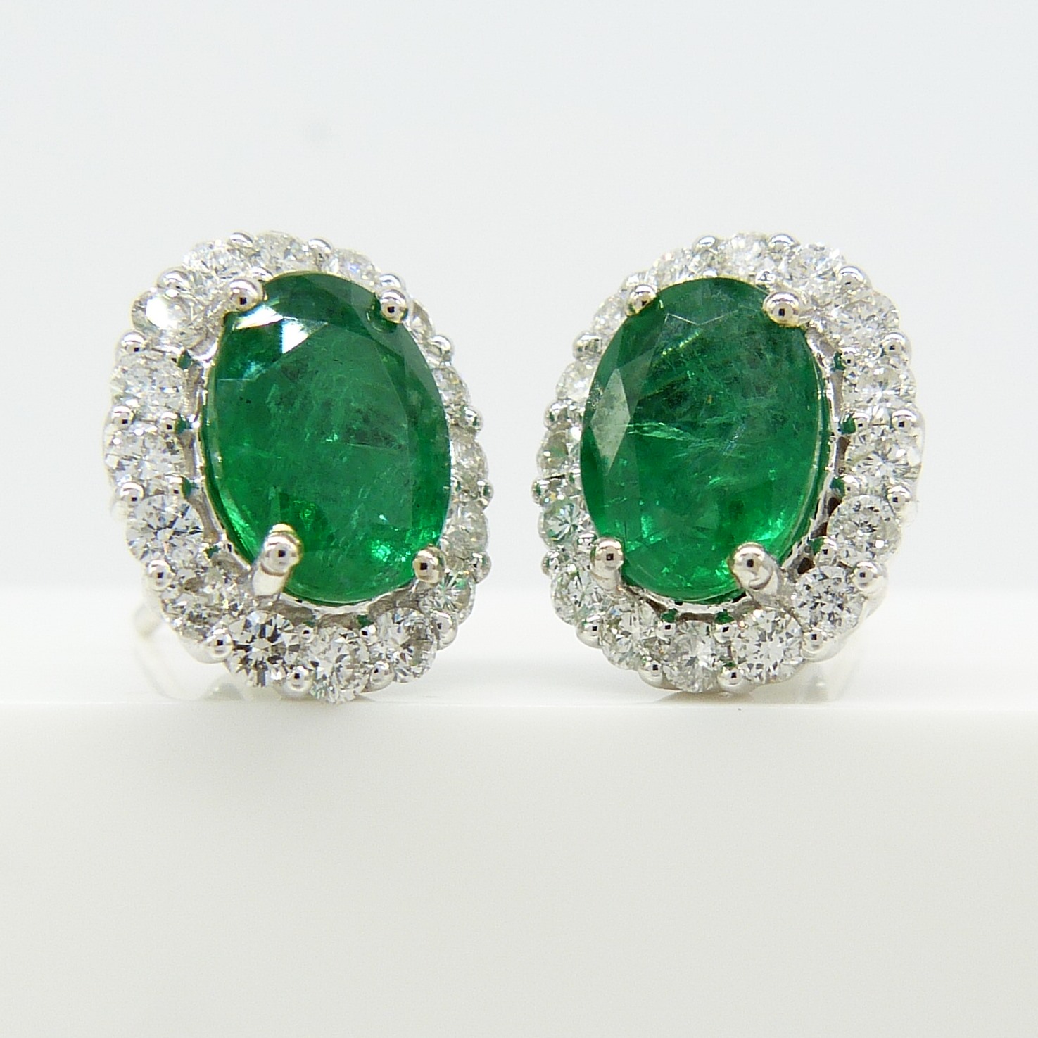 Pair of 18ct white gold 2.48 carat emerald and diamond halo ear studs, boxed - Image 5 of 8