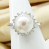 White gold round cultured freshwater pearl and diamond cluster ring in a classic style