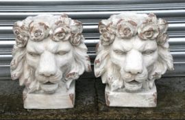 A Pair of Distressed Painted Urns in the Form of Lion Heads