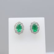 A Stylish Pair Of Oval Emerald And Diamond Cluster Stud Earrings