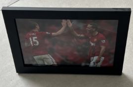 Signed framed image of 'Rio' and 'Vidic' playing for Manchester United Football Club with COA