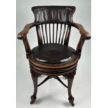 A VICTORIAN CAPTAINS CHAIR, fully revolving brown leather upholstered seat on cabriole legs with