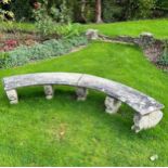 A reconstituted stone curved garden bench on five scroll supports, each marked "K" to base. 240cm