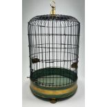 A REGENCY STYLE BRASS BIRD CAGE, green painted and raised on gilt lion paw feet 79cm x 46cm