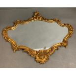 A gilt scrolled and fern wall mirror (59cm x 47cm)