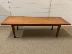 A long coffee table on tapering legs and brass detail (H42cm W149cm D49cm)