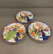 Three decorative plates with scenes of birds and floral trees