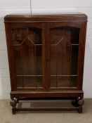 An oak glazed side cabinet (H120cm W84cm D25cm)