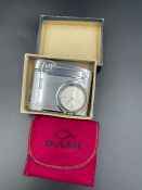 A Buler lighter with watch on the case