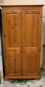 A pine double wardrobe with long mirror to inside door