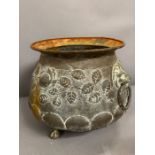 A brass flower pot on ball and claw foot and lion head to sides with ring handles