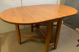 An oval kitchen/dining table (146cm x 92cm Open 38cm Folded)