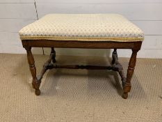 A mahogany stool with turned legs (H 42 cm x D 46cm x L 58cm)