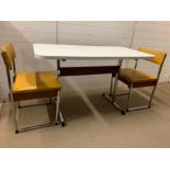 A Mid Century table and two chairs