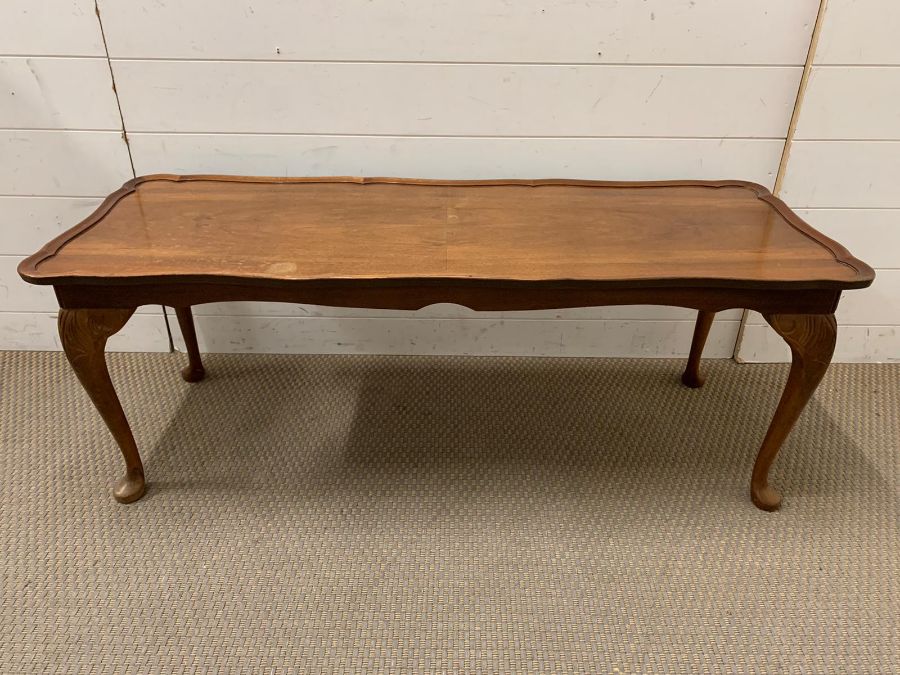 A long coffee table with scrolled/waved rim on cabriole legs (H43cm W113cm D42cm)