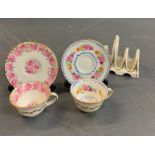 Two miniatures tea cups and saucers along with a ceramic toast rack
