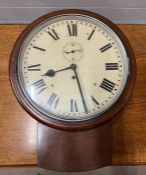 A mahogany wall clock with roman numerals