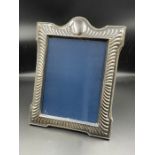 A silver photo frame, by Carr's of Sheffield 1993 hallmark. (28cm x 23cm)