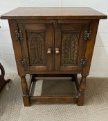 An Arts and Craft style small cabinet on legs (H69cm W51cm D32cm)