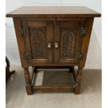 An Arts and Craft style small cabinet on legs (H69cm W51cm D32cm)