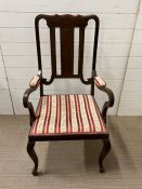 A mahogany open arm chair with padded elbow rests