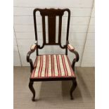 A mahogany open arm chair with padded elbow rests