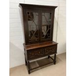 An oak cabinet on stand (H94cm W107cm D48cm)