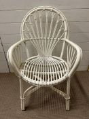 A white painted bamboo chair