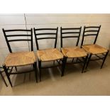 Four ebony chairs with wicker seats and rocket shape legs