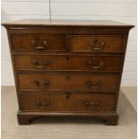 An oak chest of drawers on bracket feet (H84cm W84cm D50cm)