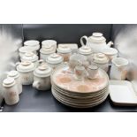 A Denby stoneware dinner service to include seven plates, soup bowls and lidded pots